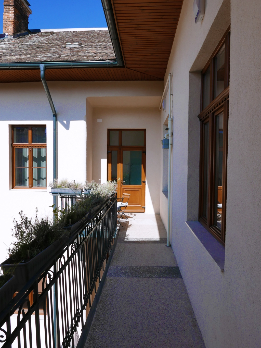 Exterior balcony walkway leading to guest rooms in our historic Cluj-Napoca building.