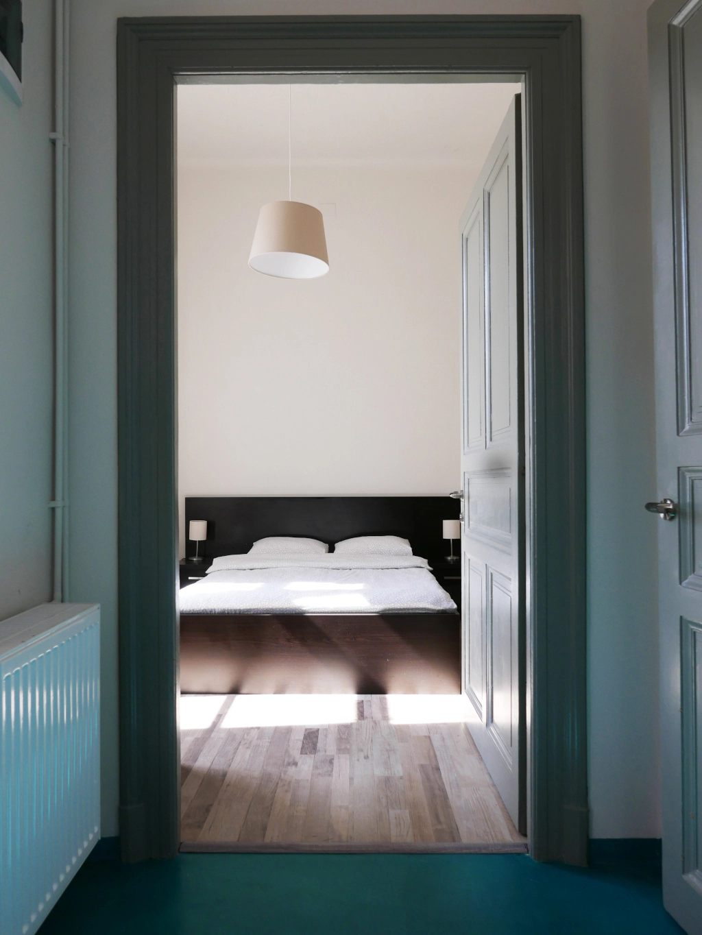 Cozy private double room with fresh bed linens and natural light at Choco Home and Hostel.