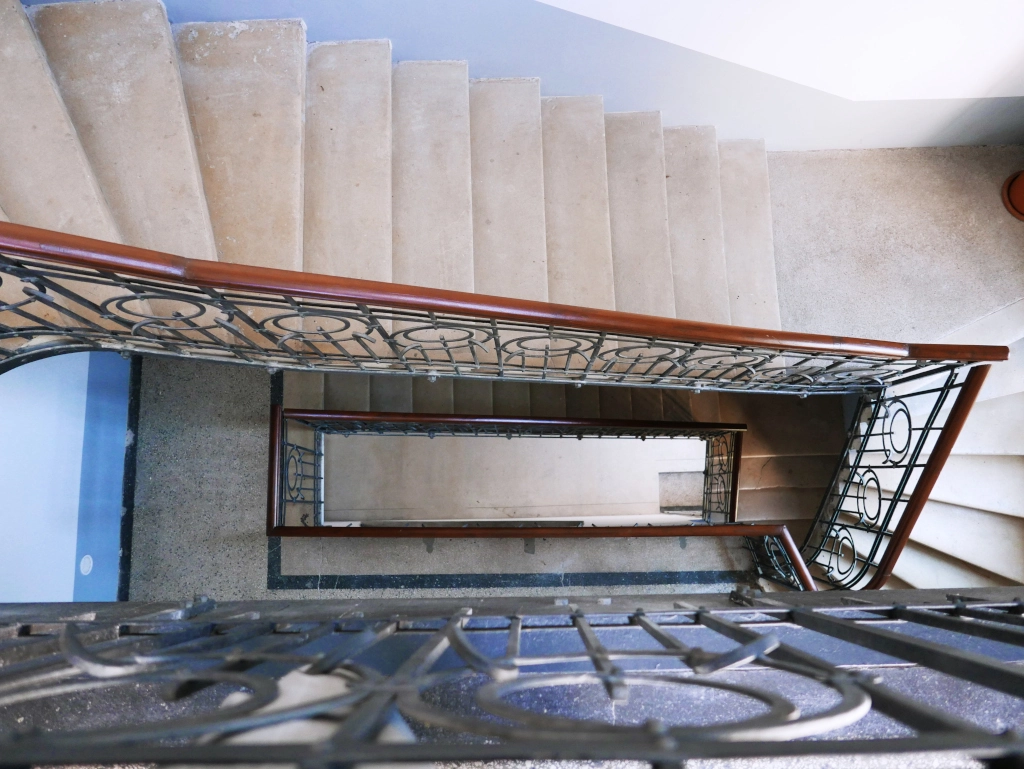 Historic wrought-iron staircase showcasing the Art Nouveau charm of the Choco Home and Hostel building.